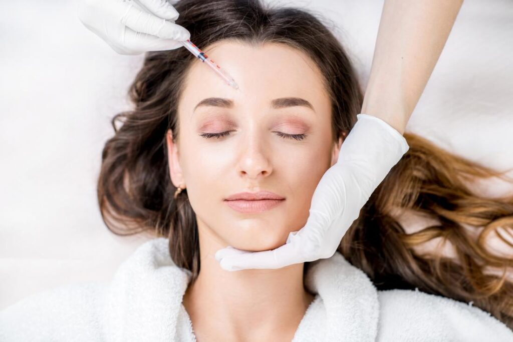 a lady is having botox and dermal filler treatment
