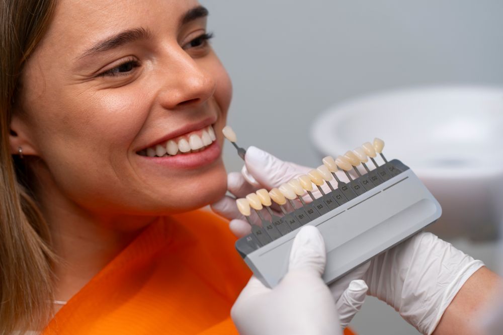 a mid age lady is smiling of having dental veneers