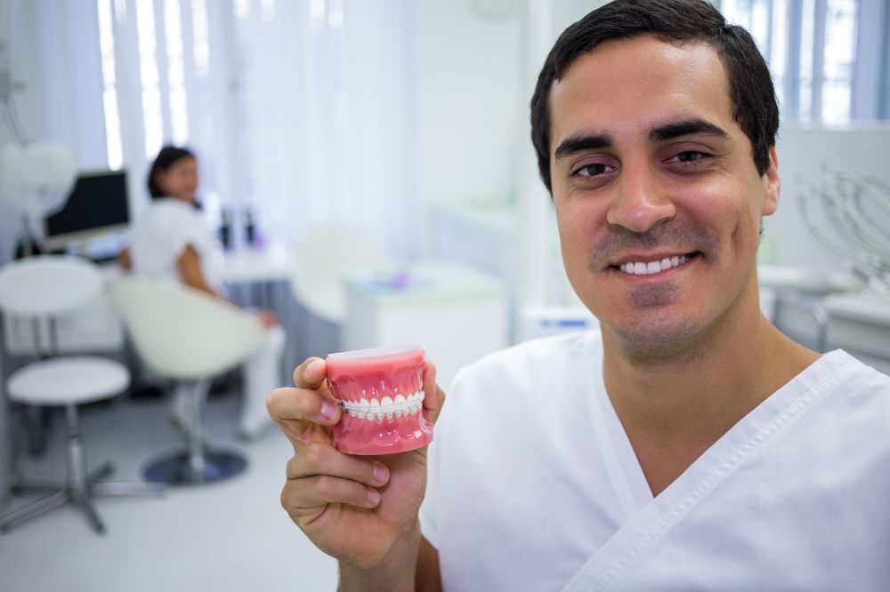 a dentist is showing demo of a dentures